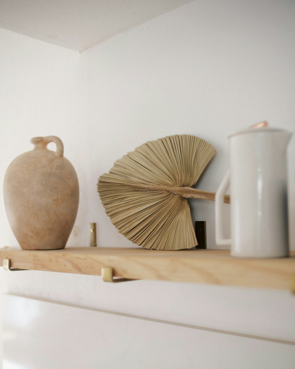 Ceramic vessels styled on a timber shelf